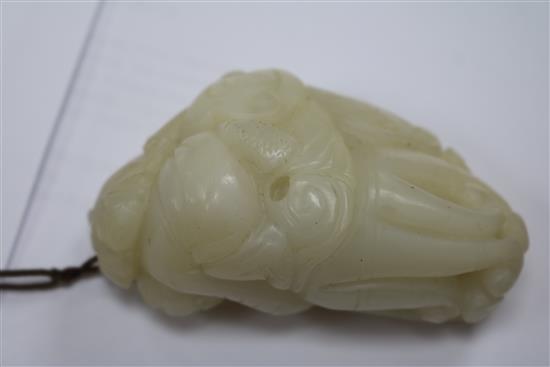 A Chinese white jade carving of a boy clambering on a finger citron, 7.7cm